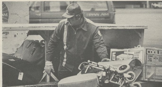 1981 A Pan Am Fleet Service Agent handling customer luggage.